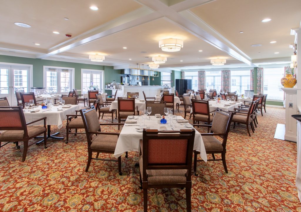 The Gardens at King Bruwaert House - Independent Living - Dining Room Show Kitchen Photograph